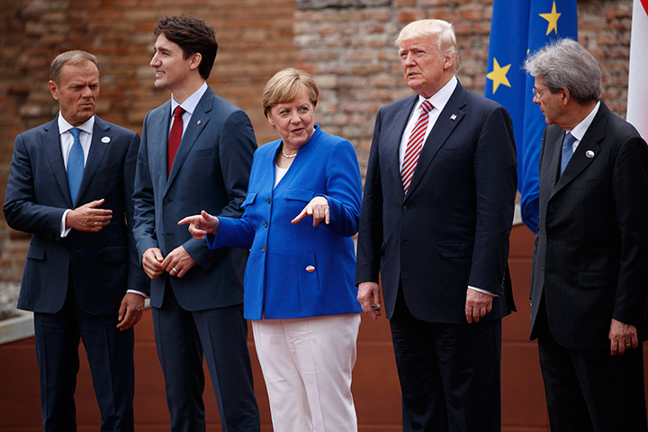 G7 leaders, from left, President of the European Commission Jean-Claude Junker, Prime Minister Justin Trudeau, German Chancellor Angela Merkel, President Donald Trump, and Italian Prime Minister Paolo Gentiloni, pose for a family photo at the Ancient Greek Theater of Taormina, Friday, May 26, 2017, in Taormina, Italy. 