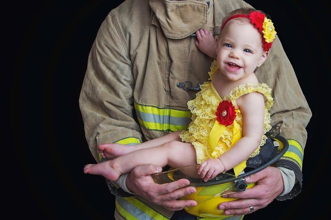 Brielle was born on May 4, 2016. Her first birthday is being marked with a photo commemorating first responders.