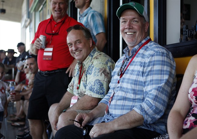 FILE PHOTO: B.C. Green party leader Andrew Weaver and B.C. NDP leader John Horgan take in the final match between Team Canada and New Zealand during cup final action at the HSBC Canada Women's Sevens at Westhills Stadium in Langford, B.C., on May 28, 2017.