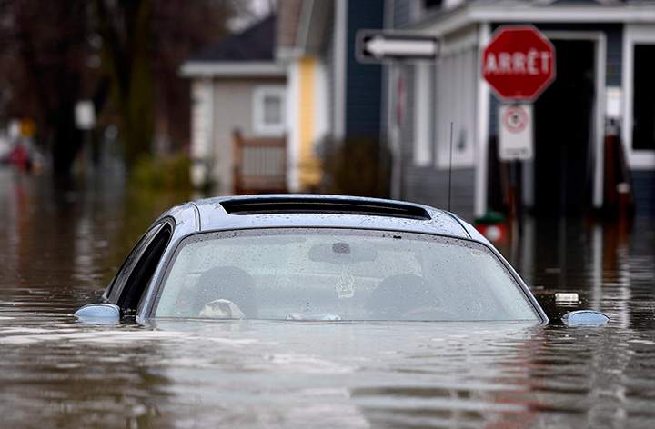 An abandoned car left in the middle of a residential street in Gatineau, Que. as rising river levels and heavy rains continue to cause flooding, on Saturday, May 6, 2017.