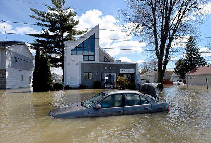 A car sits abandoned in floodwaters on Rue Saint-Louis in Gatineau on Wednesday, May 3, 2017.