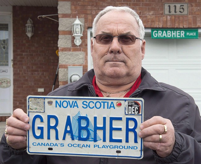Lorne Grabher displays his personalized licence plate in Dartmouth, N.S., on Friday, March 24, 2017. The Nova Scotia man is fighting to have his last name reinstated on his licence plate.