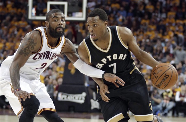 Toronto Raptors' Kyle Lowry (7) drives past Cleveland Cavaliers' Kyrie Irving (2) during the first half in Game 2 of a second-round NBA basketball playoff series in Cleveland on May 3, 2017. THE CANADIAN PRESS/AP/Tony Dejak.