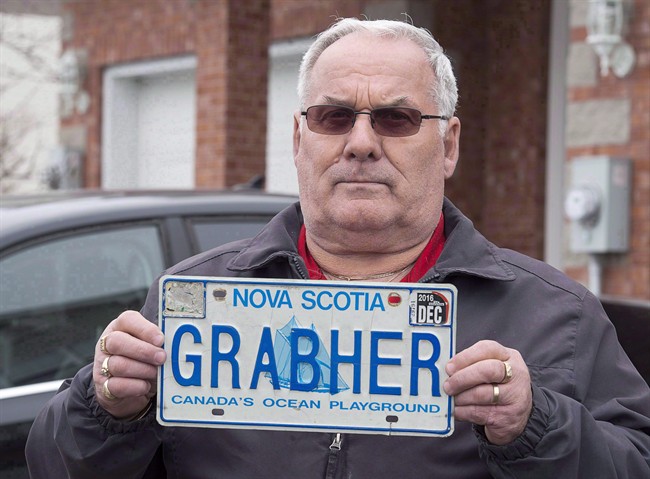 Lorne Grabher displays his personalized licence plate in Dartmouth, N.S. on Friday, March 24, 2017. A Nova Scotia man is going to court to try to have his last name ??? Grabher - reinstated on a personalized licence plate, arguing the removal violates his Charter rights despite at least one complaint that it is offensive to women.