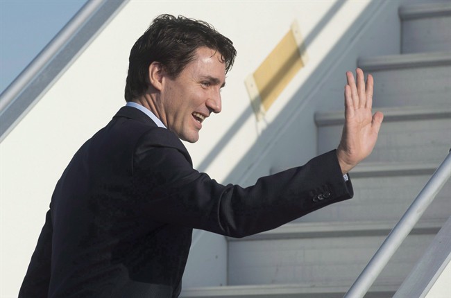 Canadian Prime Minister Justin Trudeau waves as he boards his plane in Strasbourg, France, on Thursday, February 16, 2017. 