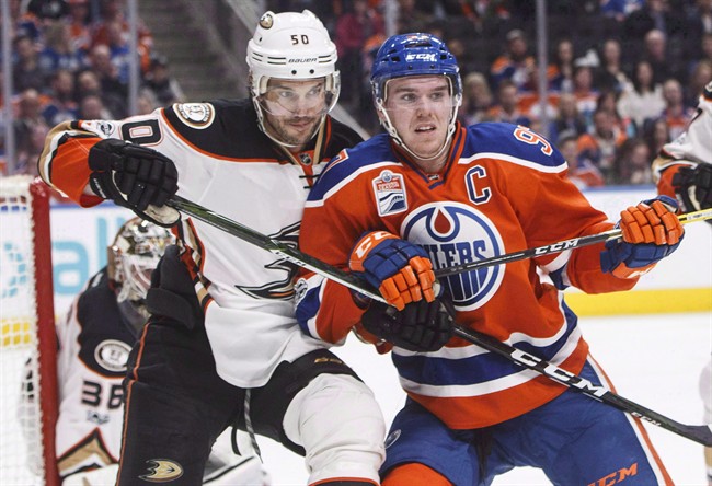 Anaheim Ducks' Antoine Vermette (50) and Edmonton Oilers' Connor McDavid (97) vie for position in front of the net during second period NHL action in Edmonton, Alta., on Saturday, April 1, 2017. First it was a jab over faceoffs, and then it was preferential treatment of NHL star Connor McDavid. Randy Carlyle's comments continue to stir the pot in Anaheim's playoff series against the Edmonton Oilers. 