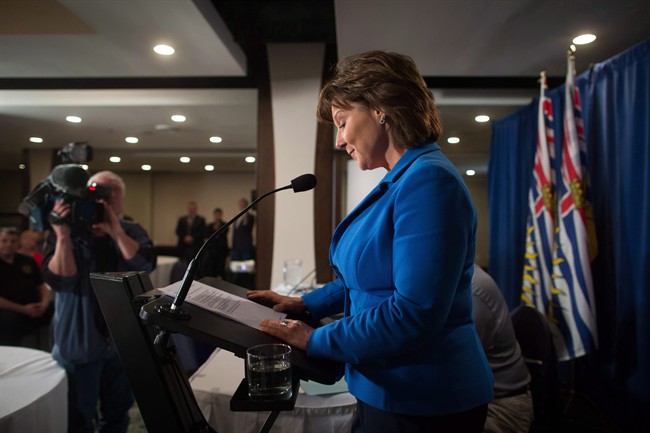 British Columbia Premier Christy Clark pauses to read her notes while addressing MLAs during a caucus meeting at a hotel in Vancouver on May 16, 2017. British Columbia's final ballot count starts Monday to determine which party forms the province's next government almost two weeks after election day, barring judicial recounts. Christy Clark's Liberals held a slight lead heading into the final count, needing only one riding to change in their favour for the slimmest of majority governments in the province's 87-seat legislature. But the prospect of a minority government also looms large.