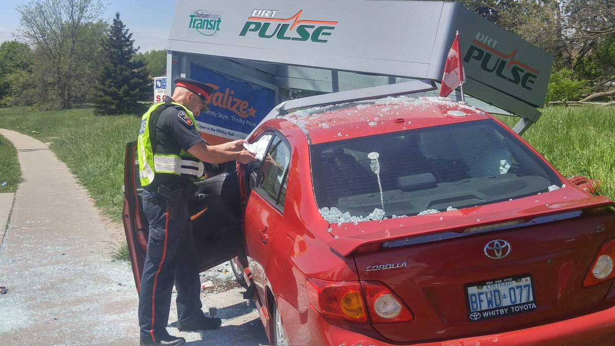 Police say two people have been transported to hospital after a car crashed into an Oshawa bus shelter.