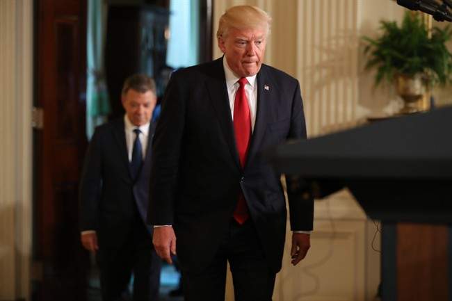 President Donald Trump, followed by Colombian President Juan Manuel Santos arrives for their joint news conference in the East Room of the White House in Washington, Thursday, May, 18, 2017. 