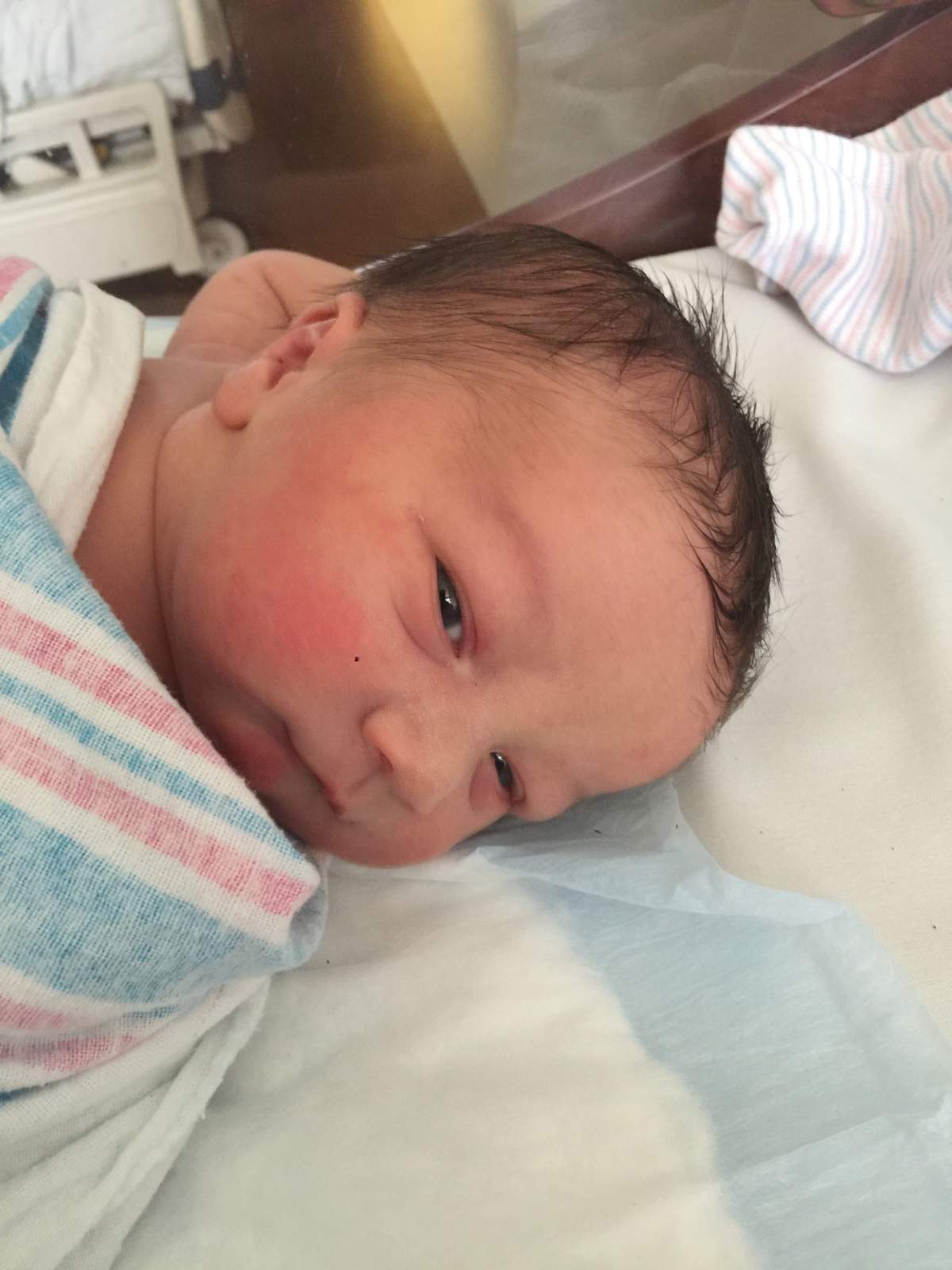 ‘Mirena baby’ photographed clutching his mother’s IUD after birth - image