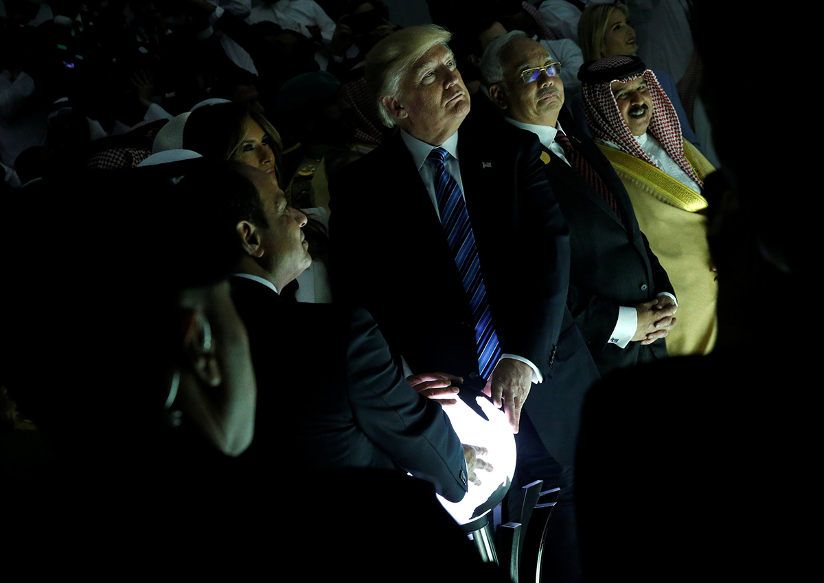 Donald Trump (C) and other leaders react to a wall of computer screens coming online as they tour the Global Center for Combatting Extremist Ideology in Riyadh, Saudi Arabia May 21, 2017. 