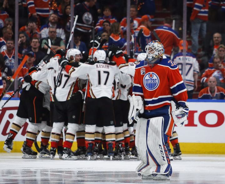 Anaheim Ducks players celebrate their victory as Edmonton Oilers goalie Cam Talbot, right, skates past during overtime NHL hockey round two playoff action in Edmonton, Wednesday, May 3, 2017.