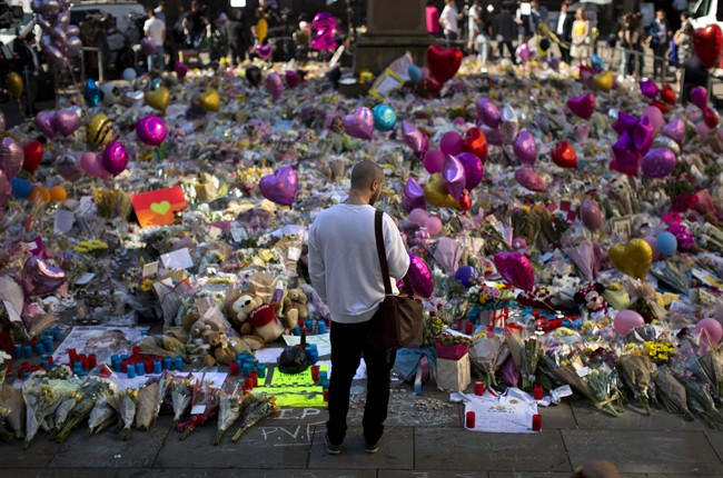 A man stands next to flowers for the victims of the Manchester bombing after an Ariana Grande concert. Urban terrorism will be discussed on the Roy Green Show.