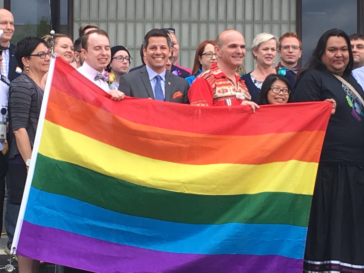 Mayor Brian Bowman in front of City Hall Friday afternoon for Pride Winnipeg's annual flag raising. 