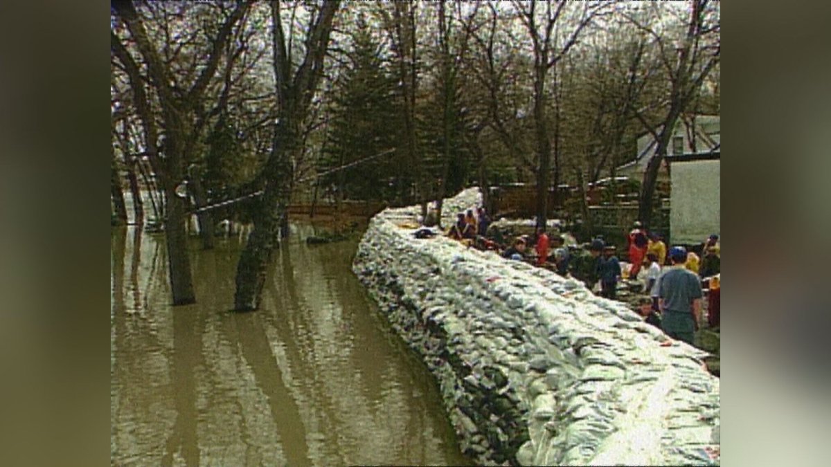 A dike holds back water during the 1997 flood that devastated much of Manitoba. 