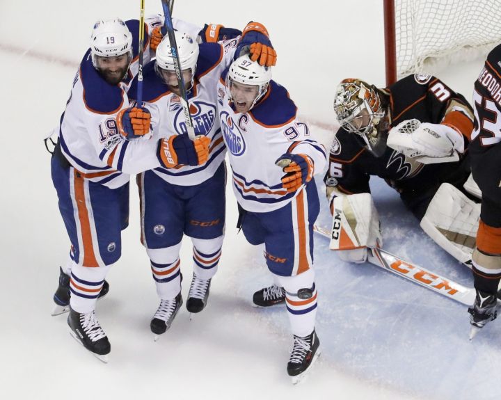Edmonton Oilers centre Drake Caggiula, second from left, celebrates with Patrick Maroon, left, and Connor McDavid after scoring past Anaheim Ducks goalie John Gibson, right, during the first period in Game 7 of a second-round NHL hockey Stanley Cup playoff series in Anaheim, Calif., Wednesday, May 10, 2017.