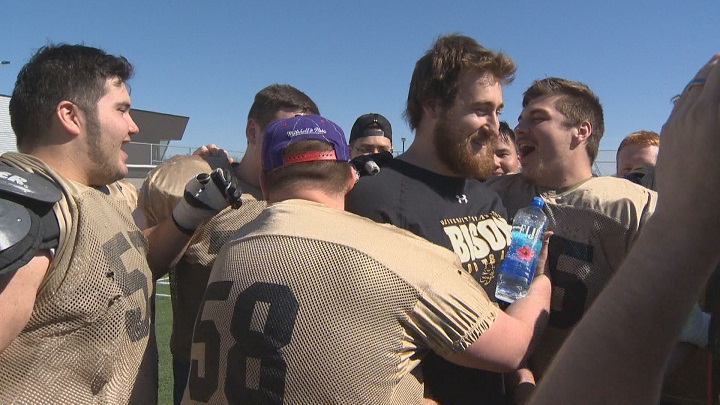 Offensive lineman Geoff Gray is surrounded by his former Manitoba Bisons' teammates after signing his first NFL contract with the Green Bay Packers.