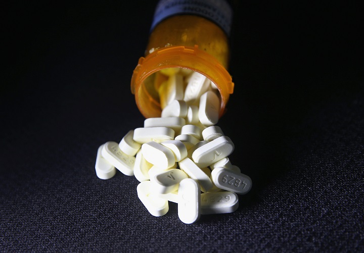 Oxycodone pain pills prescribed for a patient with chronic pain lie on display on March 23, 2016.