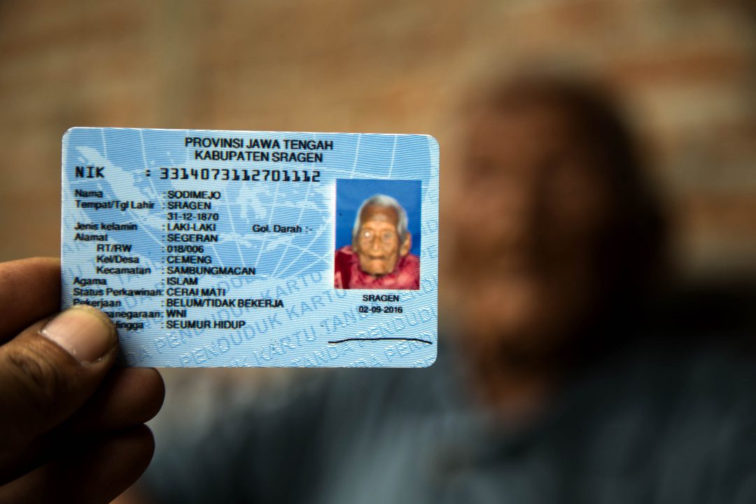 Mbah Gotho, above, with this government-issued ID. (Photo by Donal Husni/NurPhoto via Getty Images)