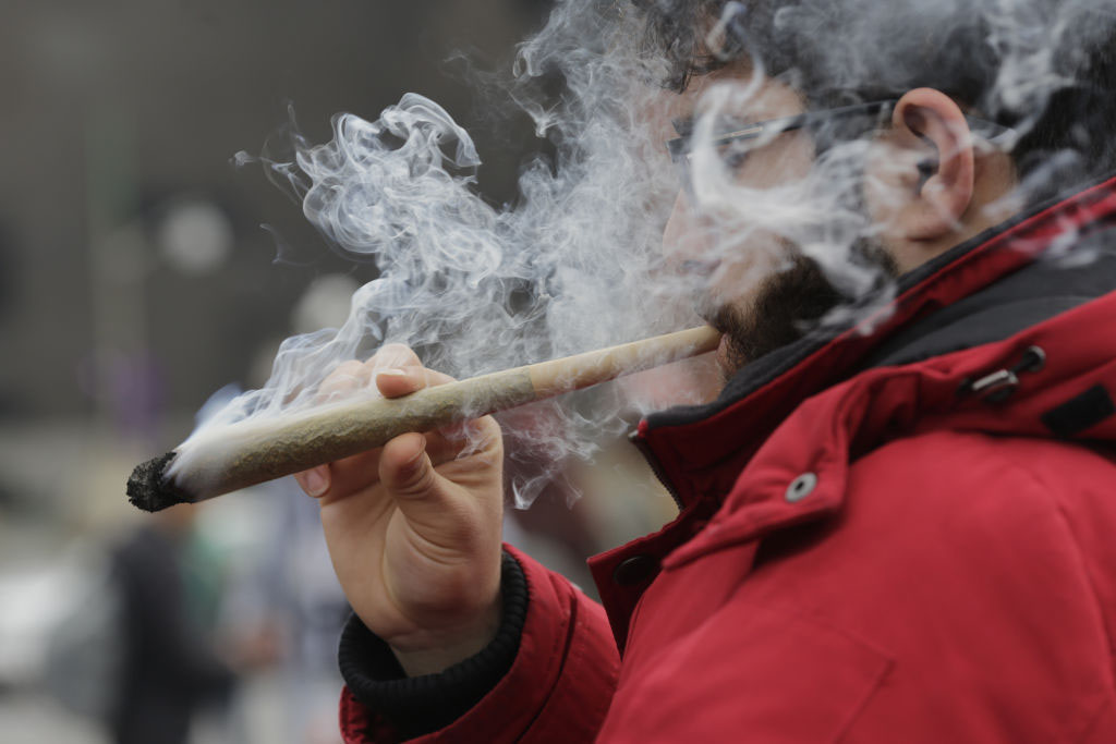 A resident smokes a large marijuana joint during the 420 Day festival on the lawns of Parliament Hill in Ottawa, on Thursday, April 20, 2017. 