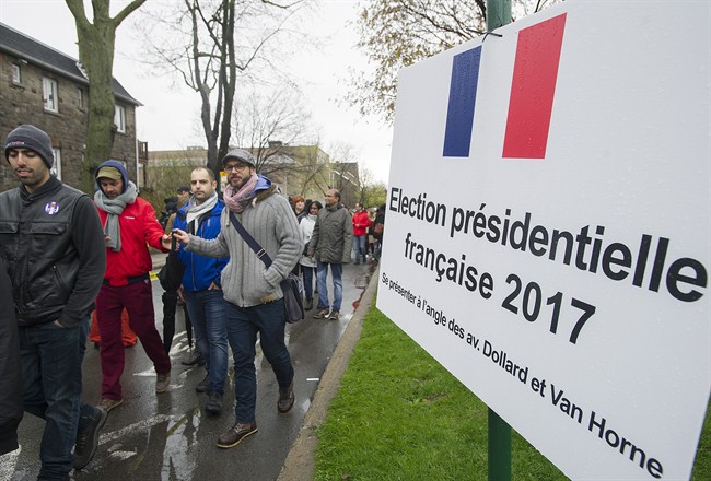 French expats wait in line to vote in the second round of voting in the 2017 French Presidential election in Montreal, Saturday, May 6, 2017. France goes to the polls on Sunday. 