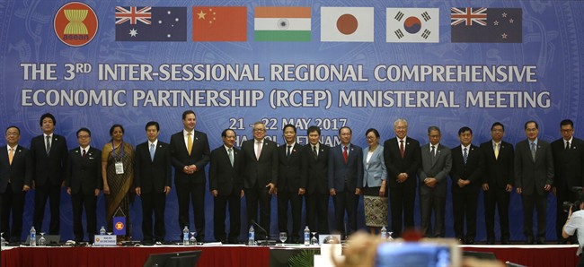 FILE - Trade ministers of 16 countries from the Asia-Pacific region stand for a group photo during the Regional Comprehensive Economic Partnership (RCEP) ministerial meeting in Hanoi, Vietnam on Monday, May 22, 2017.