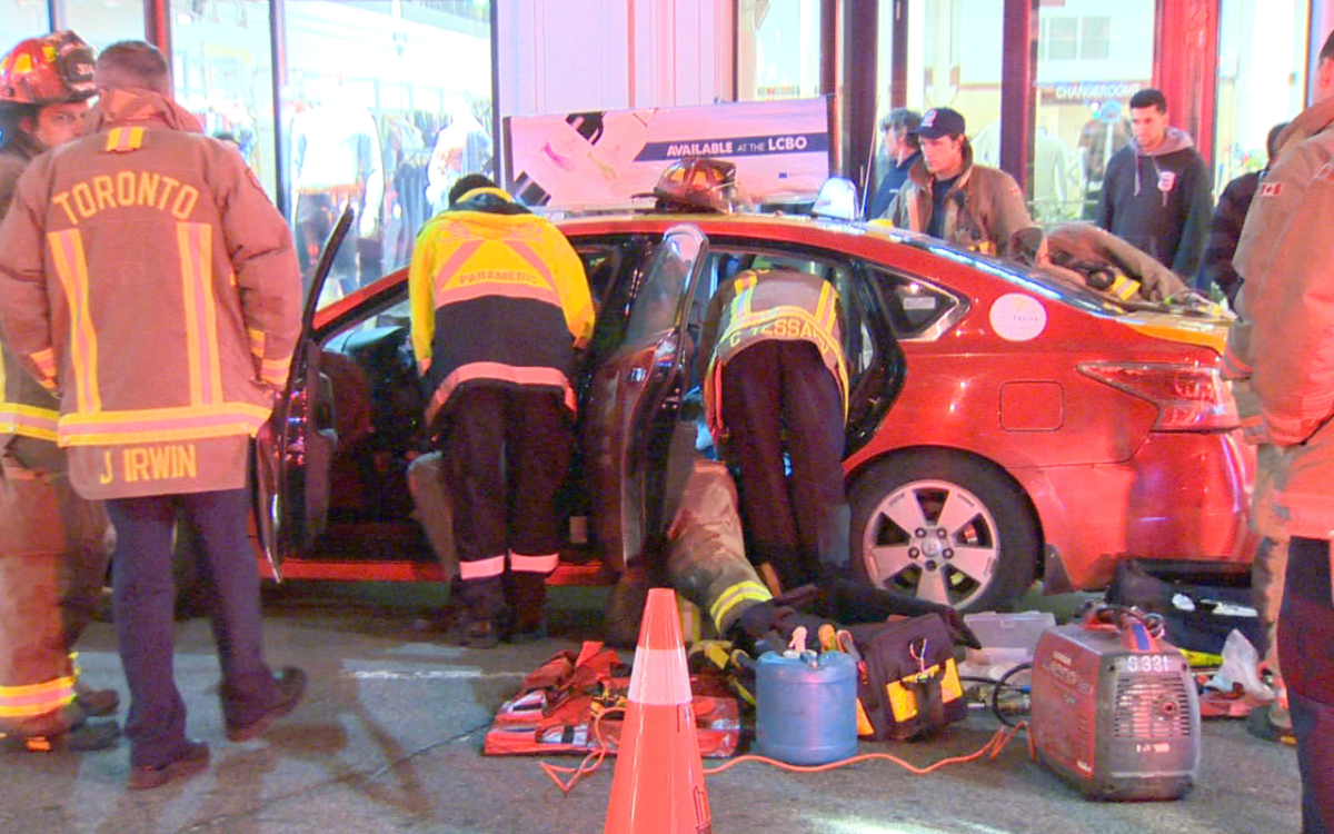 Emergency crews attend to a driver who had his hand stuck in a taxi on Yonge and Shuter Street on May 10, 2017.