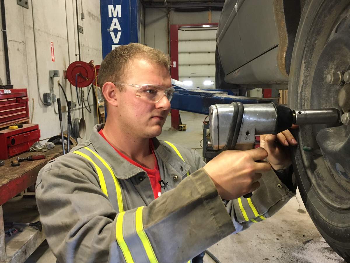 Tyler works on a car as part of his treatment with the Adult and Teen Challenge treatment program.