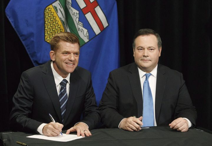 Alberta Wildrose leader Brian Jean and Alberta PC leader Jason Kenney sign a unity deal between the two in Edmonton on Thursday, May 18, 2017.