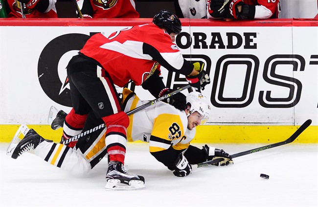 Ottawa Senators defenceman Marc Methot (3) takes down Pittsburgh Penguins centre Sidney Crosby (87) during the third period of game six of the Eastern Conference final in the NHL Stanley Cup hockey playoffs in Ottawa on Tuesday, May 23, 2017. THE CANADIAN PRESS/Sean Kilpatrick.