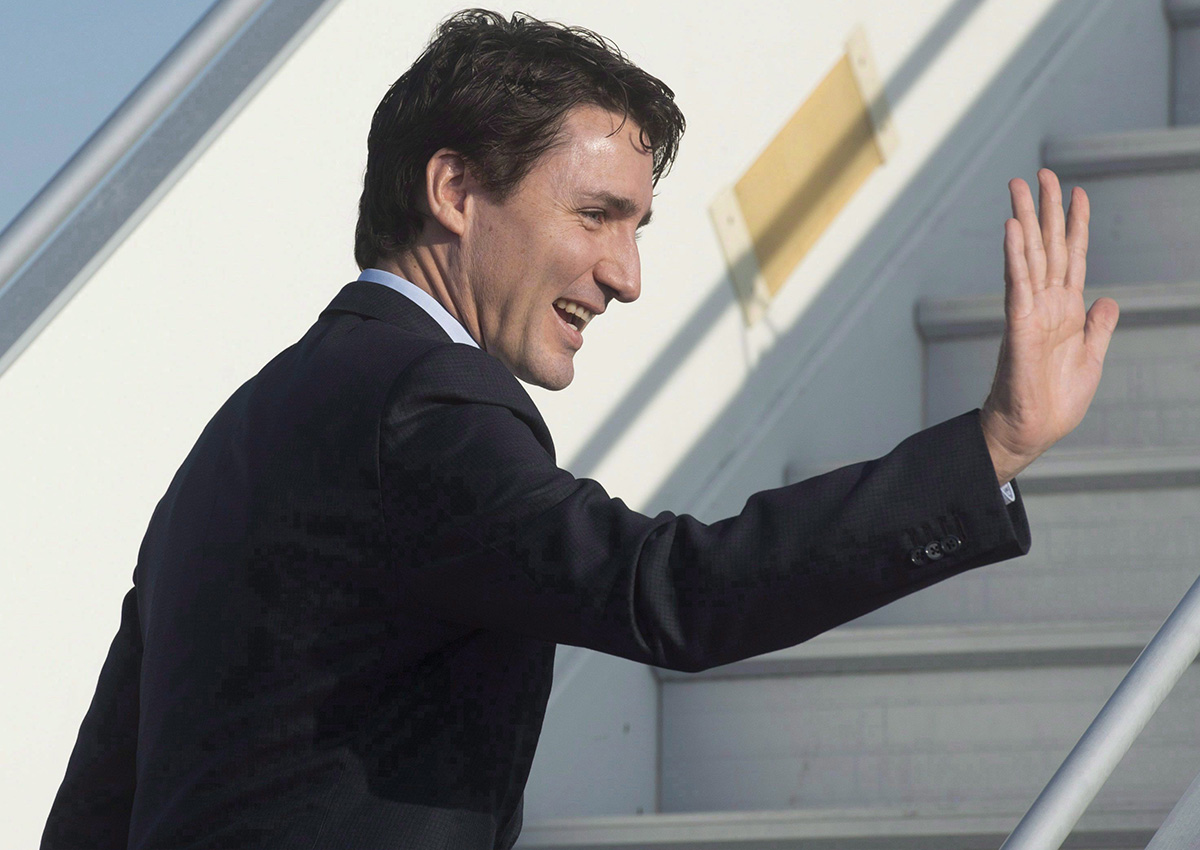 Canadian Prime Minister Justin Trudeau waves as he boards his plane in Strasbourg, France, on Thursday, February 16, 2017.