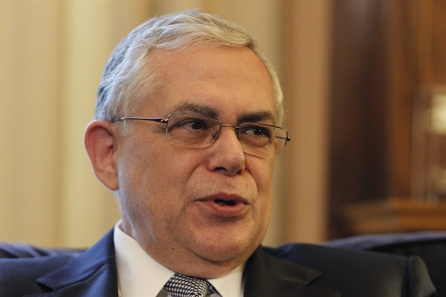In this May 11, 2012 file photo, Greek Prime Minister Lucas Papademos speaks to Greek President Karolos Papoulias during their meeting at the presidential palace in Athens. 