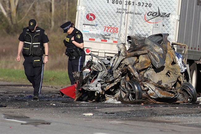 OPP officers attend the site of a crash in the westbound 401, northeast of Kingston, Ont. early Thursday May 11, 2017.