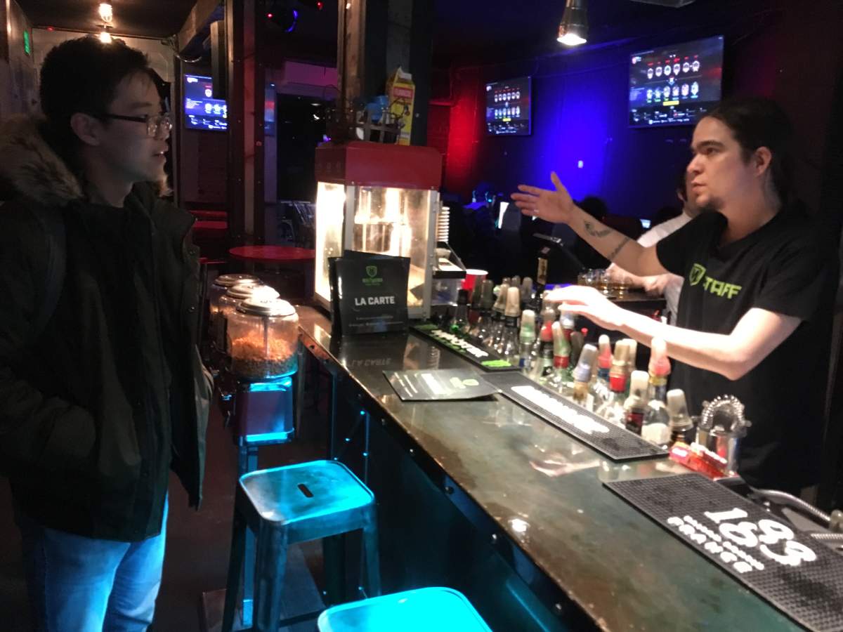 Meltdown Montreal co-owner gives run-down of the gaming bar to a new visitor.