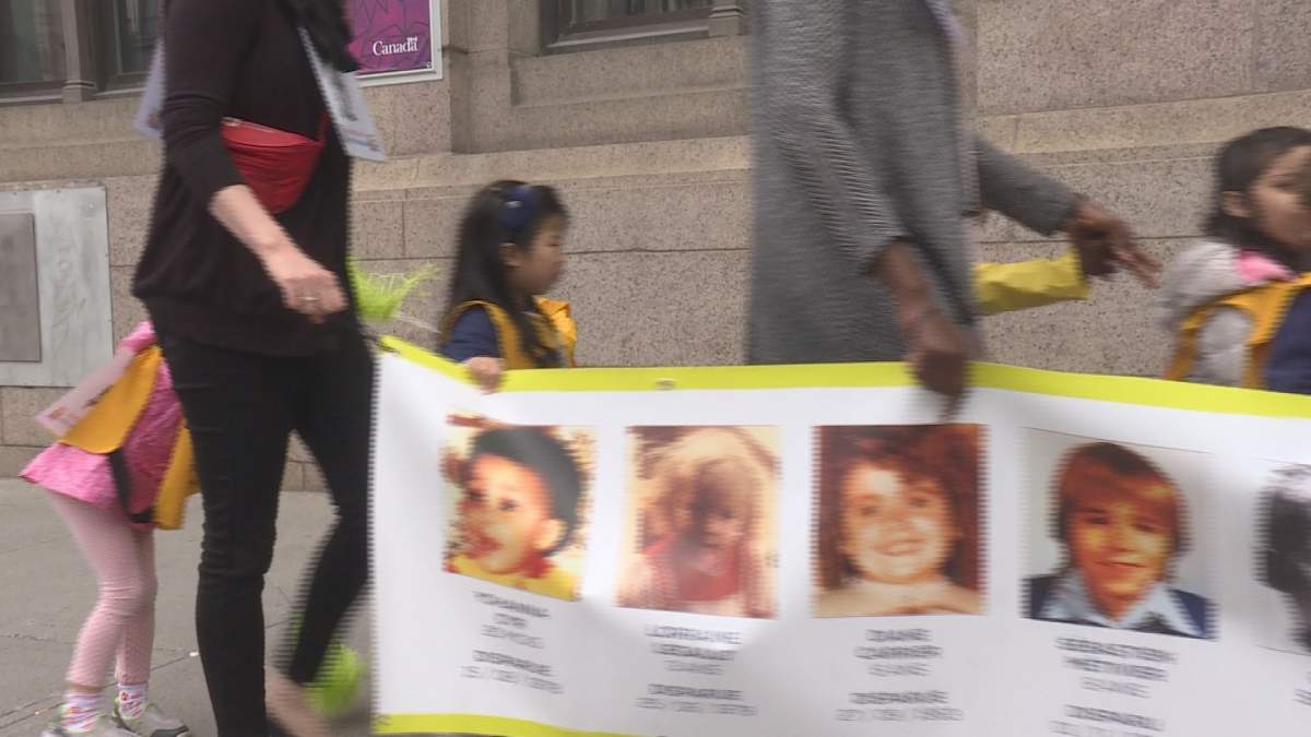 Daycare children walk to remember missing kids, Thursday, May 25, 2017.