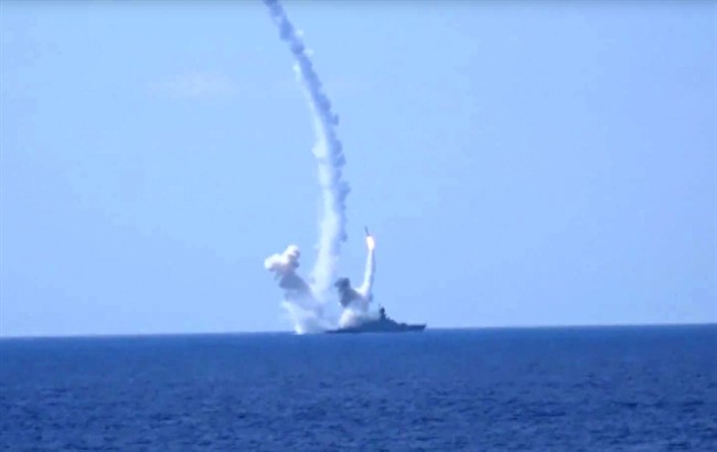 FILE- In this Friday, Aug. 19, 2016, file frame grab provided by Russian Defense Ministry press service, long-range Kalibr cruise missiles are launched by a Russian Navy ship in the eastern Mediterranean.