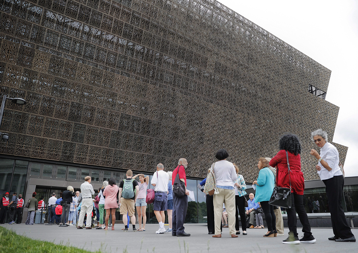 People wait in line to enter the Smithsonian National Museum of African American History and Cultural on the National Mall in Washington, Monday, May 1, 2017. 