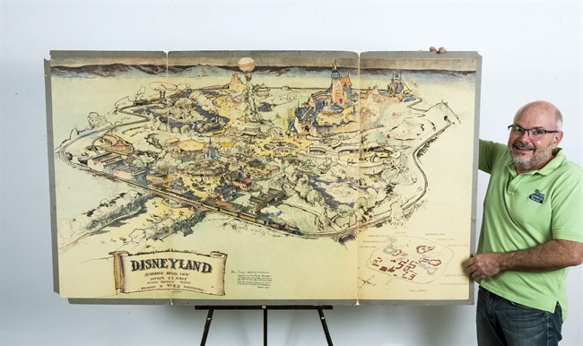 Art dealer Mike Van Eaton stands next to a hand-drawn map from 1953 that shows Walt Disney's original ideas for Disneyland.