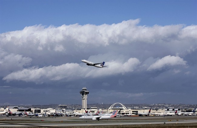 A plane flies over Los Angeles airport in a file photo. Canadian Chaoyi Le was taken into custody Friday after getting off a flight from Shanghai.