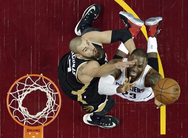 Toronto Raptors' Jonas Valanciunas, left, defends Cleveland Cavaliers' LeBron James during the first half in Game 2 of a second-round NBA basketball playoff series, Wednesday, May 3, 2017, in Cleveland. 