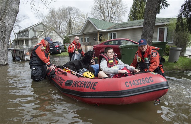 Residents are evacuated from their homes following an overnight flash flooding Wednesday, May 3, 2017 in Montreal.