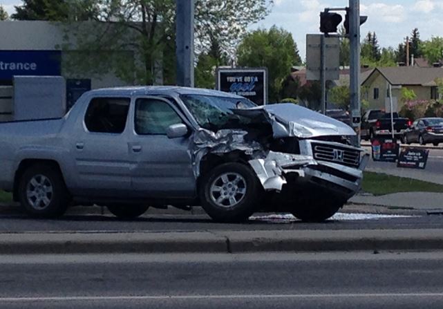 A pick-up truck is seen damaged after colliding with a semi-truck in northeast Calgary Saturday afternoon. 