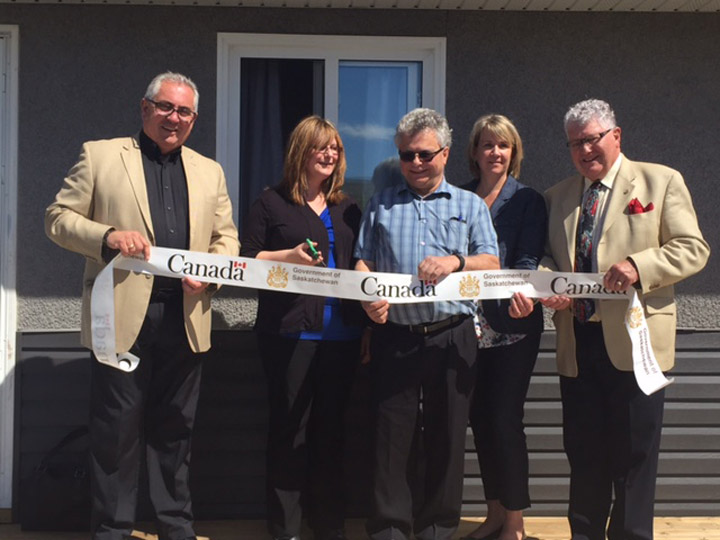 Ribbon cutting at the official open of four new single-family affordable homes in Prince Albert, Sask.
