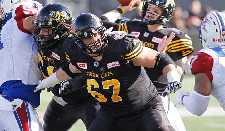 HAMILTON, ON - November 5: Mike Filer #51 and Peter Dyakowski #67 of the Hamilton Tiger-Cats block for Jeff Mathews #9 of the Hamilton Tiger-Cats against the Montreal Alouettes during a CFL game at Tim Hortons Field on November 5, 2016 in Hamilton, Ontario, Canada. Montreal defeated Hamilton 32-25. (Photo by John E. Sokolowski/Getty Images)