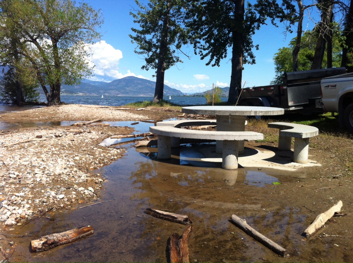 Okanagan Lake now covers most of the beach at Sarsons Park in Kelowna with picnic tables now submerged in water.