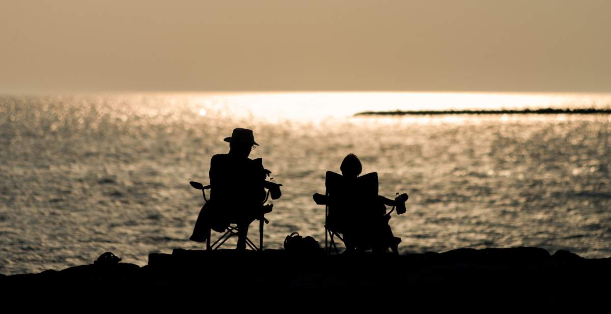 A couple sit in chairs along the shoreline of Lake Huron in Goderich.