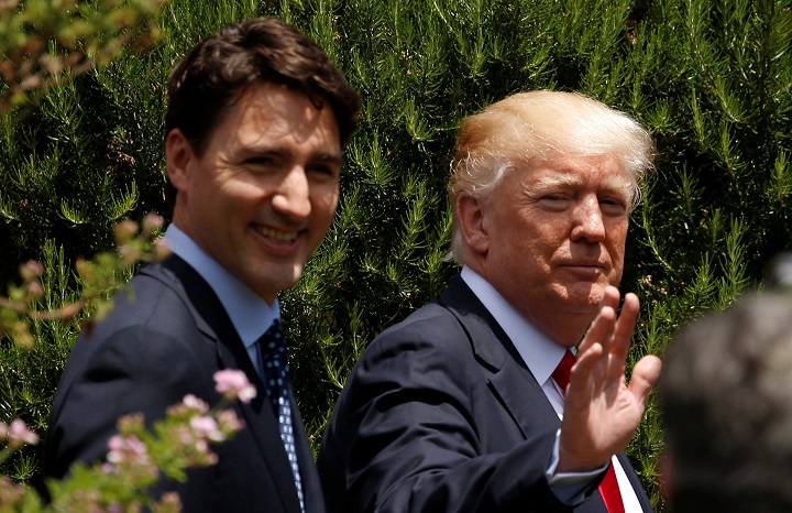 Donald Trump waves next to Justin Trudeau following a family photo at the G7 Summit expanded session in Taormina, Sicily, Italy May 27, 2017. Canada will stick with the Paris Accord regardless of Trump's decision on the climate pact, says Ottawa.