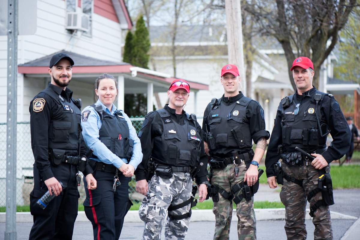 Montreal police officers help flood victims in Île Bizard in Montreal's West Island.