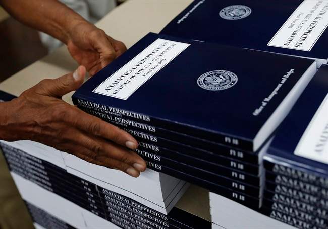 In this photo taken May 19, 2017, a GPO worker stacks copies of "Analytical Perspectives Budget of the U.S. Government Fiscal Year 2018" onto a pallet at the U.S. Government Publishing Office's (GPO) plant in Washington. (AP Photo/Carolyn Kaster).