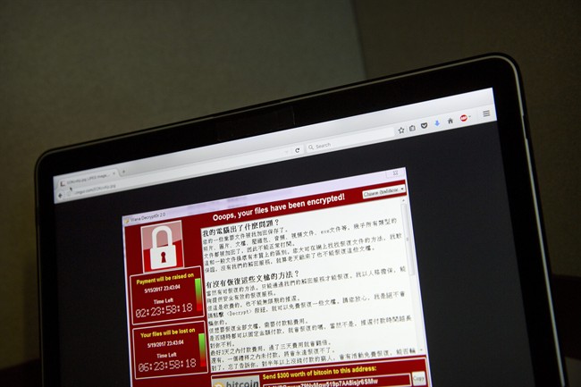 A screenshot of the warning screen from a purported ransomware attack, as captured by a computer user in Taiwan, is seen on laptop in Beijing, Saturday, May 13, 2017.